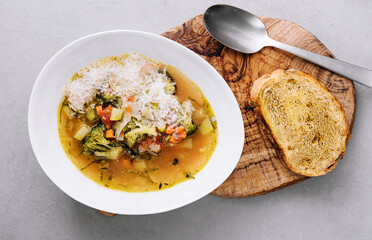 Freshly cooked broccoli cheese soup in a bowl with toast