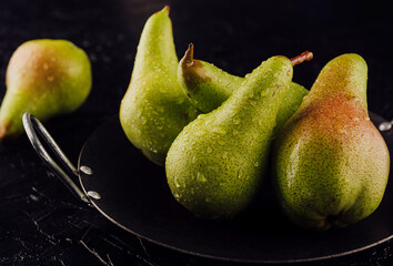 Fototapeta na wymiar Fresh ripe organic yellow pears with water drops