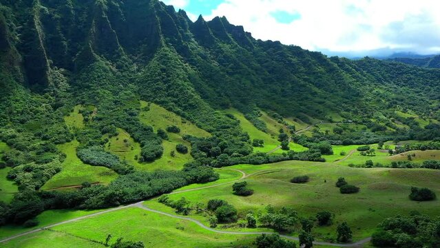 Aerial Forward Shot Of Landscape With Green Plants And Mountains Against Cloudy Sky - Kaneohe, Hawaii