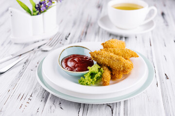 Fried chicken nuggets with ketchup on plate