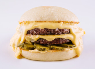 hamburger with two cutlets, pickled cucumbers and melted cheese