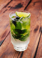 glass of fresh Mojito on wooden