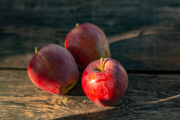 Ripe red apples on wooden background .