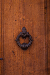 Ancient old doorn knocks in San Gimignano