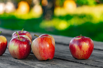 Ripe red apples on wooden background .