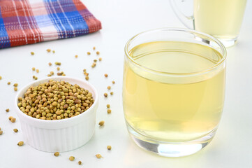 Coriander seed water in a glass cup.