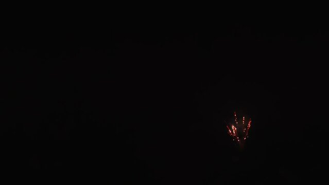 Colorful fireworks festival. Beautiful sparkling fireworks in slow motion. Wonderful real fireworks in the night sky shot with a telephoto lens. fireworks show. 4K slow motion video.