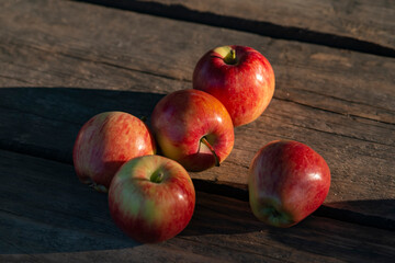 Ripe red apples on wooden background .