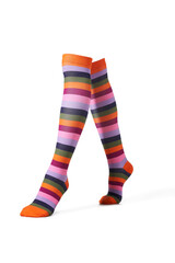Detailed shot of color bright knee-high socks with a rubber band and a striped print. The socks are shaped as human legs. The unisex knee socks are isolated on a white background.