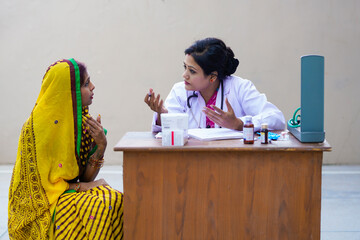 Young indian woman doctor advise to rural woman at clinic