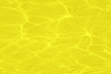Defocus blurred transparent yellow colored clear calm water surface texture with splashes and bubbles. Trendy abstract nature background. Water waves in sunlight with caustics. Gold watercolor shine