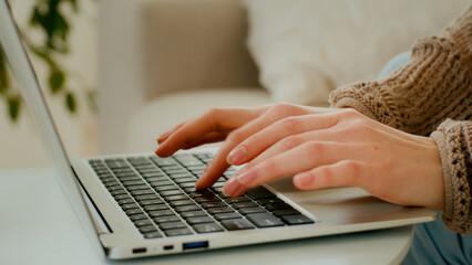 Close up female hands of unrecognizable business woman professional user worker using typing on laptop. Cropped view unknown girl working with computer keyboard sit at home office working online chat