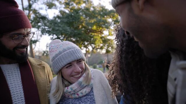 Happy Portrait, slow motion panning of multiethnic group of friends laughing while embracing each other, outdoors in the city, having fun and enjoying of their company. Headshot.