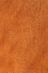 Fototapeta premium Orange and gusty wall. Vertical image. Space for advertising.