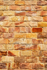 Wall of colored cracked bricks. Vertical image. Advertising space.