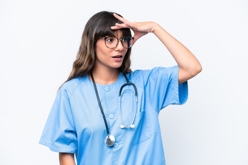 Young caucasian nurse woman isolated on white background doing surprise gesture while looking to the side