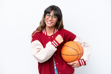 Young caucasian woman playing basketball isolated on white background celebrating a victory