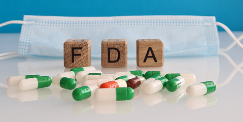 Food and Drug Administration. Medical protective mask and pills FDA drug approval concept