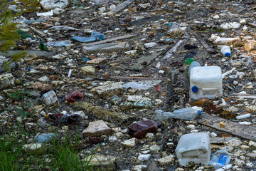 Garbage dump in pond. City dump on the territory of the river. Environmental pollution by household waste. Ecological disaster in undeveloped countries. Garbage in the forest and on the seashore
