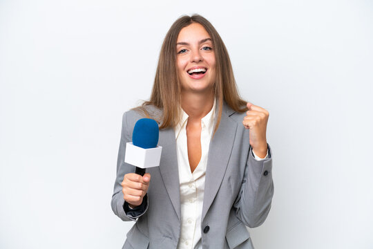 Young TV presenter caucasian woman isolated on white background celebrating a victory in winner position