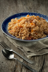A plate of pilaf on an oak table