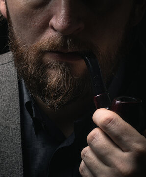 stylish man in retro outfit suit hat smoking wooden pipe sherlock holmes look cosplay england gentleman fashionable confident gangster Guy Ritchie Charlie Hunnam style