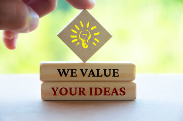 We value your ideas text on wooden blocks. Feedback and review concept