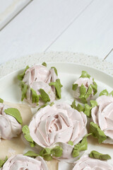 Homemade zephyr roses dry on a tray. On a white background. Close-up.