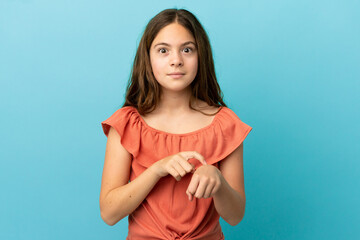 Obraz premium Little caucasian girl isolated on blue background making the gesture of being late