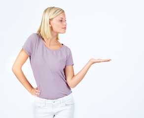 Woman, showing and hand for marketing space, advertising mock up and product placement mockup on studio background. Model, hand gesture and promotion for sales deal, logo branding and about us design