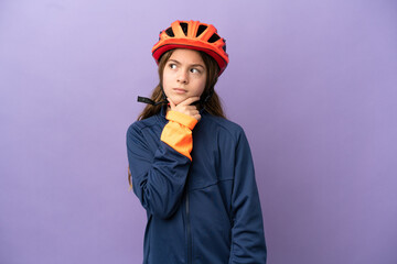Little caucasian girl isolated on purple background having doubts