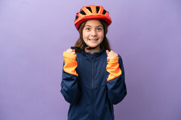 Little caucasian girl isolated on purple background celebrating a victory in winner position