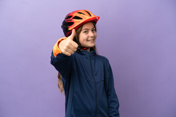 Little caucasian girl isolated on purple background with thumbs up because something good has happened