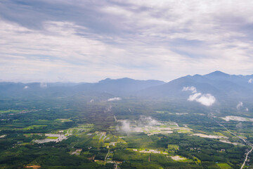 Aerial view of mountain hills and rural valley with white cloud on journey time.