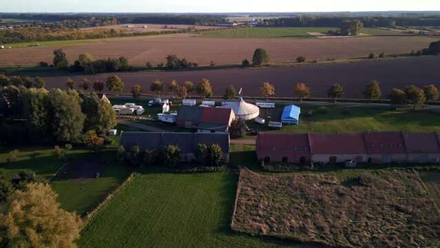 Rural village autumn landscape, circus tent. Fantastic aerial view flight drone
