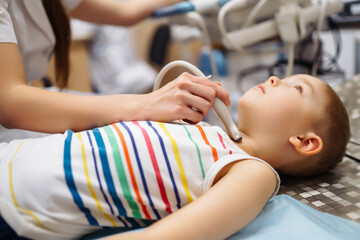 Little boy undergoing ultrasound at clinic.  Сhild's health.