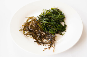 白い背景の生と茹でたアカモク