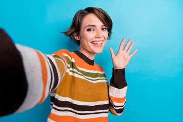 Photo of cheerful optimistic woman with short hairstyle dressed striped jumper doing selfie say hi isolated on blue color background - obrazy, fototapety, plakaty