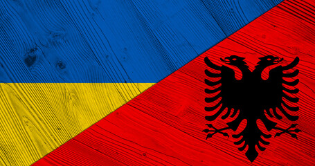 Background with flag of Ukraine and Albania on wooden split plank. 3d illustration