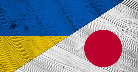 Background with flag of Ukraine and Japan on wooden split board. 3d illustration