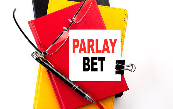 PARLAY BET text written on a sticky on colorful notebooks