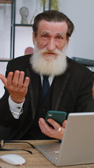 Senior businessman use smartphone typing browsing, loses becoming surprised sudden lottery results,...