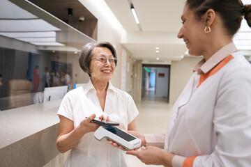 Patient pays for her visit to the therapist