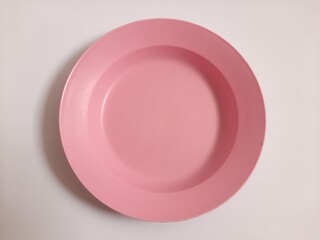 Top view empty plastic pink plate on isolated white background