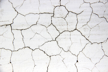 White cement walls, old, dirty and cracked surfaces.
