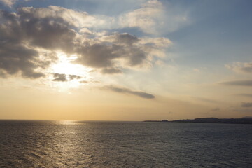 Naklejka na ściany i meble Sun in clouds over the mediterranean sea