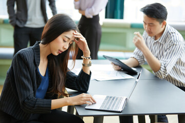 businesswoman feeling tired from overworked with laptop computer on the table