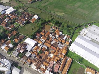 Obraz premium Aerial view of housing adjacent to agricultural land in the Cikancung area