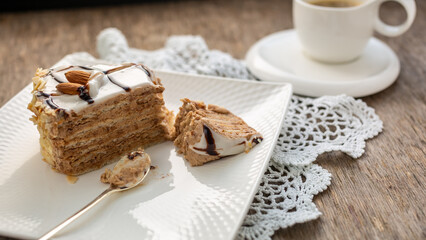 Obraz na płótnie Canvas Piece of almond cake and white cup with tea