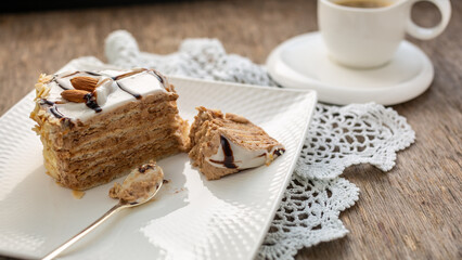 Piece of almond cake and white cup with tea